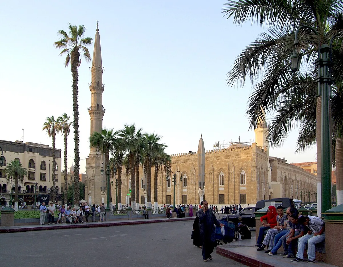 Al-Hussein Mosque in Cairo - A grand mosque and mausoleum with a gold-domed shrine, flanked by a minaret, standing at...