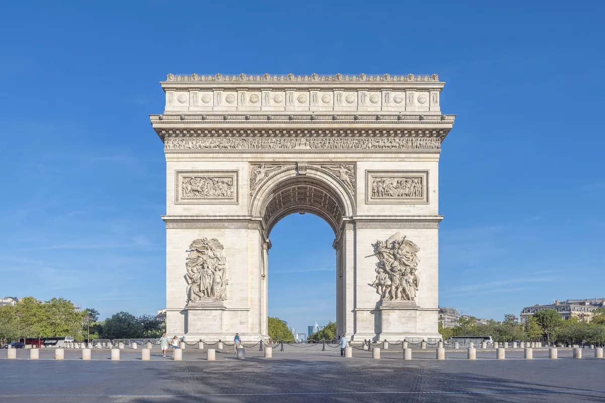 Arc de Triomphe in Paris - A massive neoclassical triumphal arch standing at the centre of Place Charles de Gaulle, where twelve avenues radiate outward in a star pattern