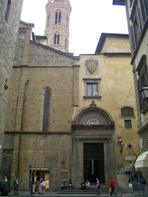 Badia Fiorentina in Florence - A quiet church squeezed between buildings on a narrow street, whose hexagonal bell tower...