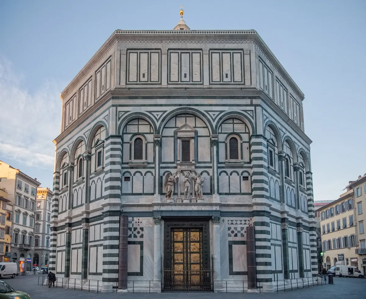 Baptistery of San Giovanni in Florence - An octagonal marble building with a green-and-white striped exterior and a...