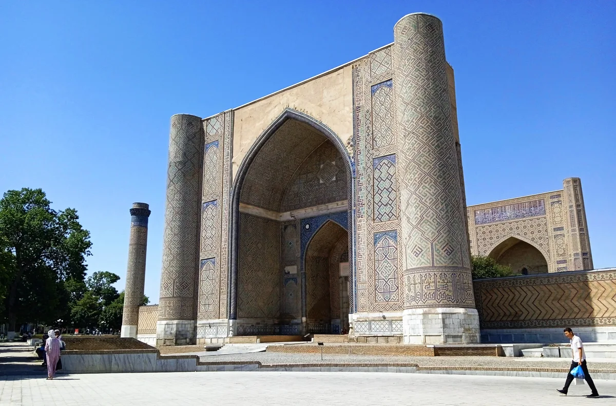 Bibi-Khanym Mosque in Samarkand - A colossal blue-domed mosque stands at the edge of a vast courtyard: a towering...