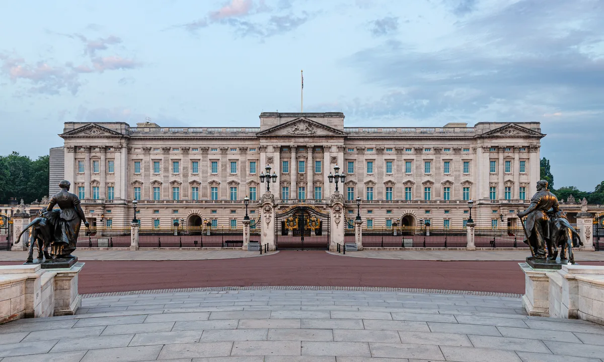 Buckingham Palace in London - A grand Neoclassical palace with a Portland stone facade, a central balcony above the...