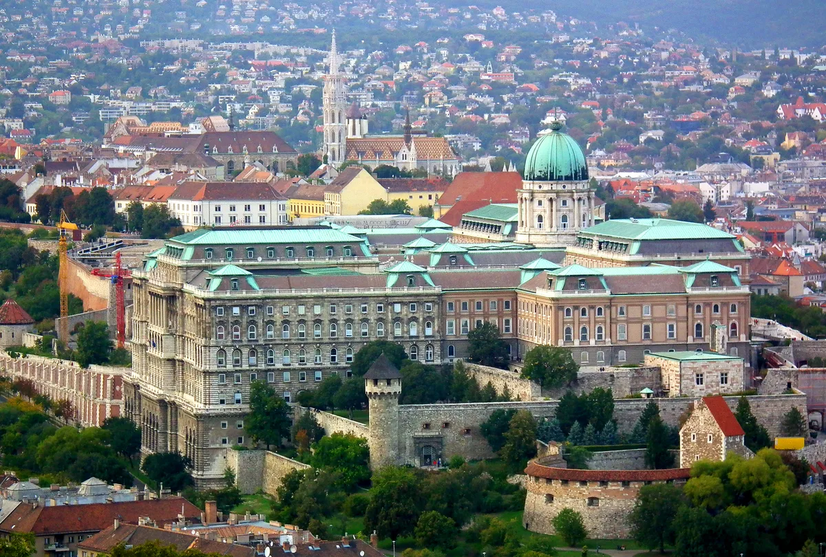 Buda Castle in Budapest - A vast palace complex crowning the southern end of Castle Hill, with a central dome, long...