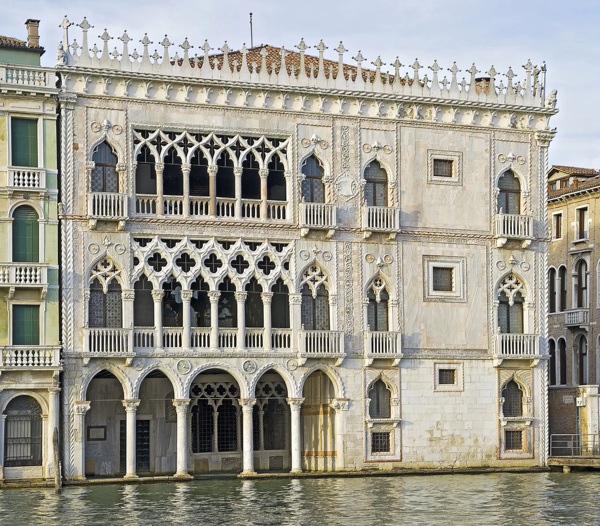 Ca' d'Oro in Venice - A lace-like facade of pointed arches, quatrefoil tracery, and slender columns in white and pale...
