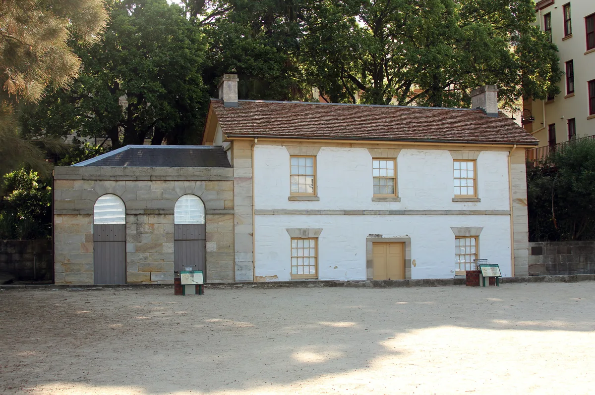 Cadman's Cottage in Sydney - A small two-storey sandstone cottage with a steep shingled roof and iron-lattice windows...