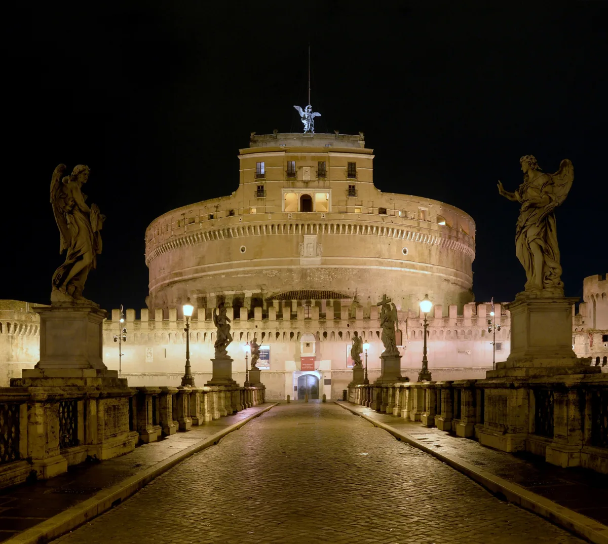 Castel Sant'Angelo in Rome - A towering cylindrical structure on the banks of the Tiber, crowned by a bronze statue of...