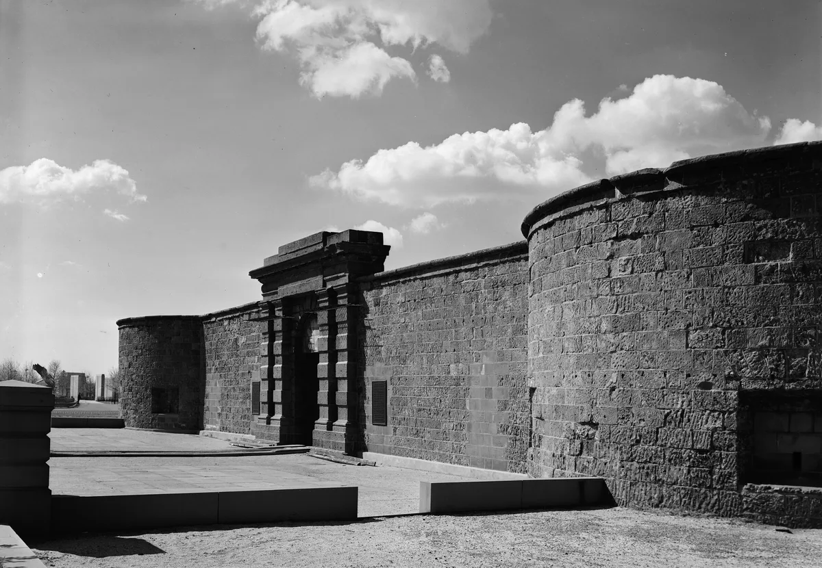 Castle Clinton in New York - A circular brownstone fort with thick curved walls and a flat roof, sitting at the...