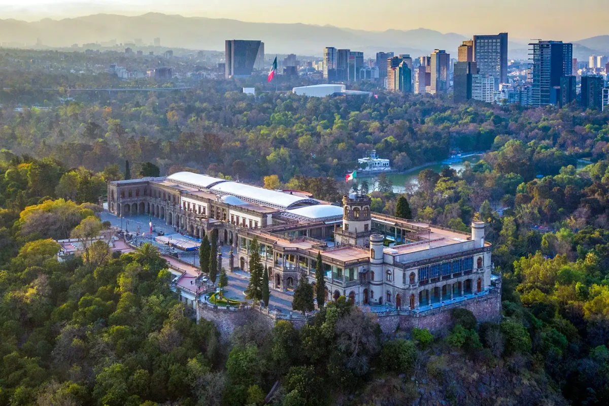 Chapultepec Castle in Mexico City - A grand palace atop a wooded hill, with a neoclassical facade, manicured gardens...