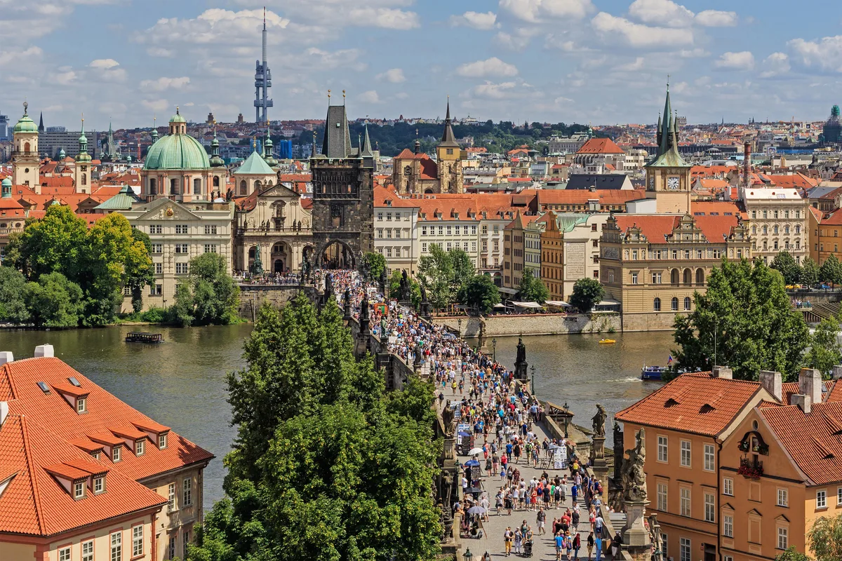 Charles Bridge in Prague - A 516-metre stone bridge lined with 30 Baroque statues, connecting the Old Town to the...