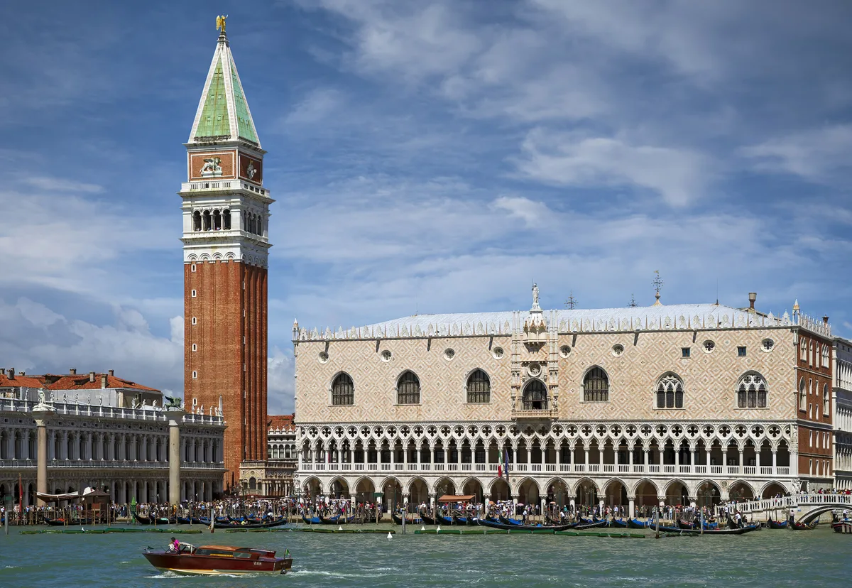 Doge's Palace in Venice - A pink-and-white diamond-patterned wall floats above two open arcades of pointed arches and...