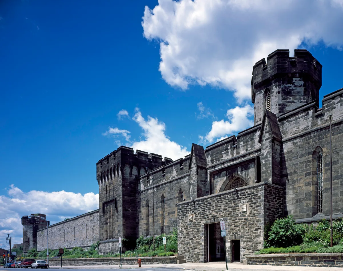 Eastern State Penitentiary in Philadelphia - A fortress-like stone facade with a Gothic gateway, leading into a...