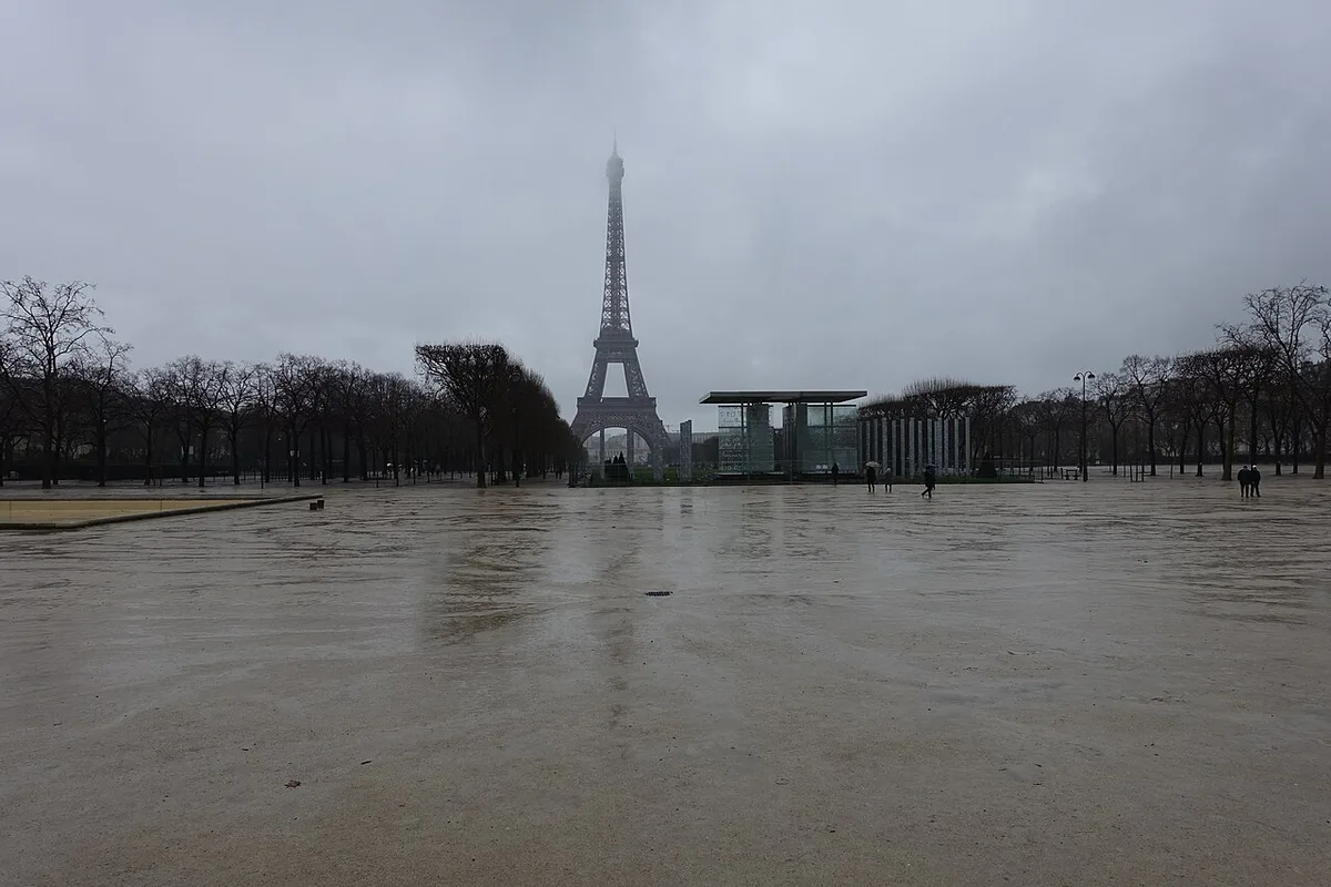 Eiffel Tower in Paris - An iron lattice tower rising 330 meters above the Champ de Mars, tapering upward from four...
