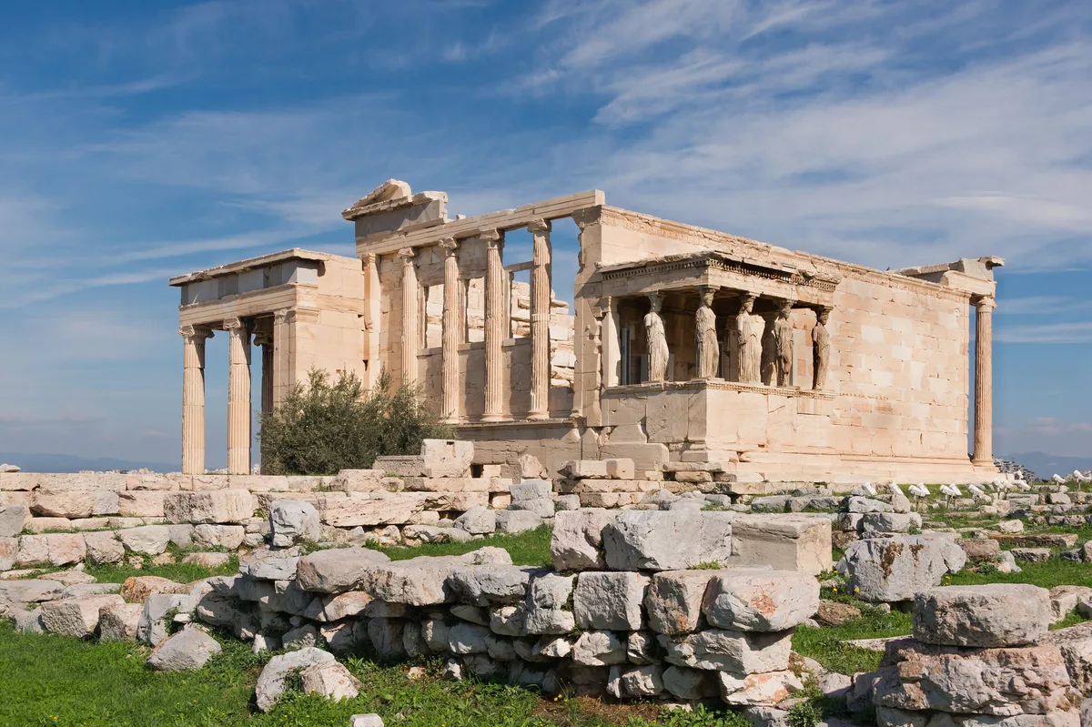 Erechtheion in Athens - An asymmetric marble temple on the Acropolis with an iconic south porch where six sculpted...
