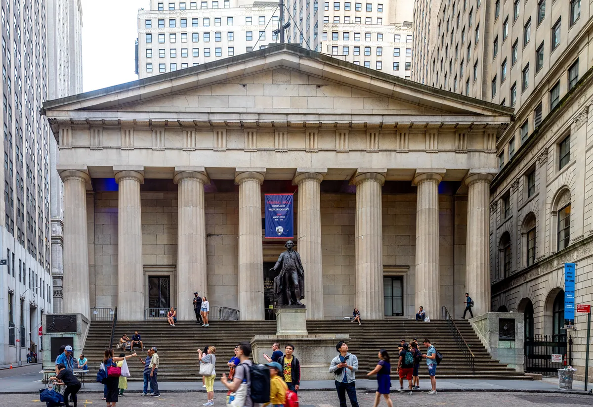 Federal Hall in New York - A marble Greek Revival temple with a row of Doric columns across its front, standing at the...