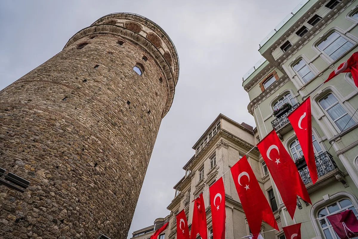 Galata Tower in Istanbul - A stone cylindrical tower rising above the historic Galata neighborhood, topped by a conical...