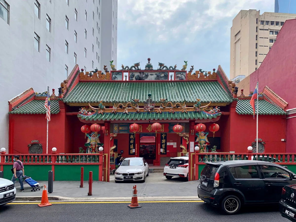 Guan Di Temple in Kuala Lumpur - A striking red-and-green Chinese temple set within a busy neighbourhood, its sweeping...