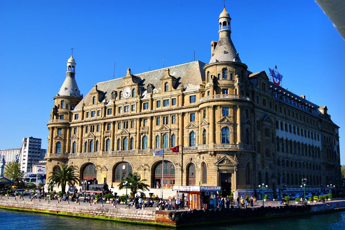 Haydarpaşa Railway Station (Haydarpaşa Garı) in Istanbul - A grand stone station with corner towers and a gabled roofline rising directly above the Bosphorus waterfront on the Asian shore.