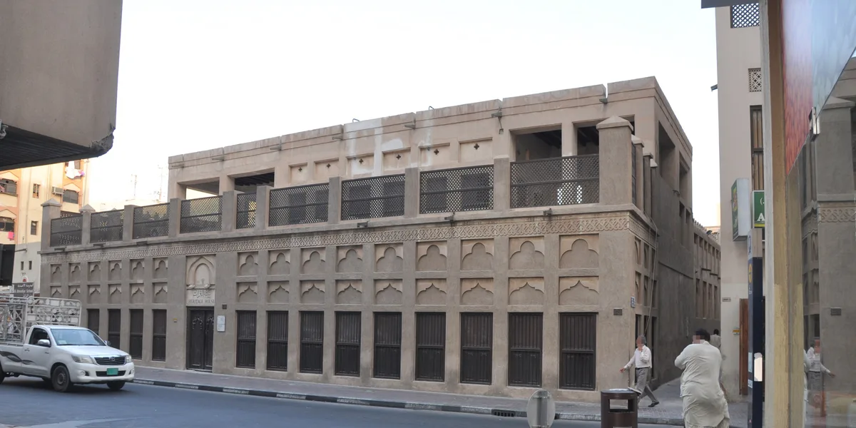 Heritage House in Dubai - The wide two-storey facade of the merchant's courtyard house in the old quarter, seen from across the street