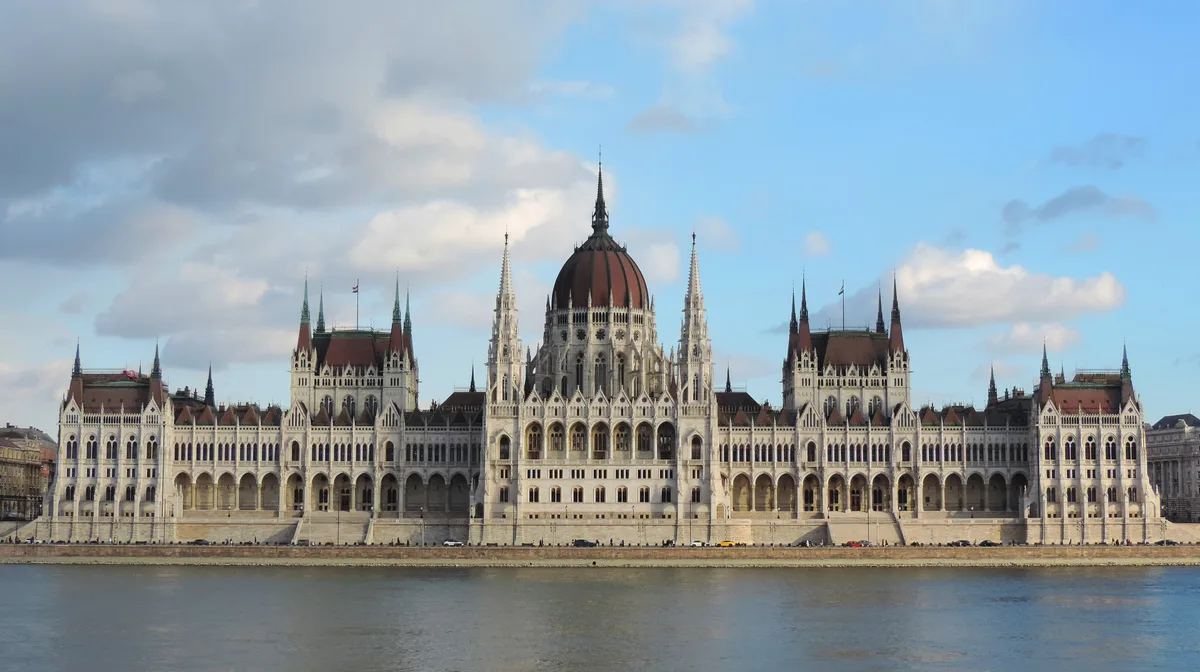 Hungarian Parliament Building in Budapest - An immense neo-Gothic palace stretching along the Danube, its soaring...