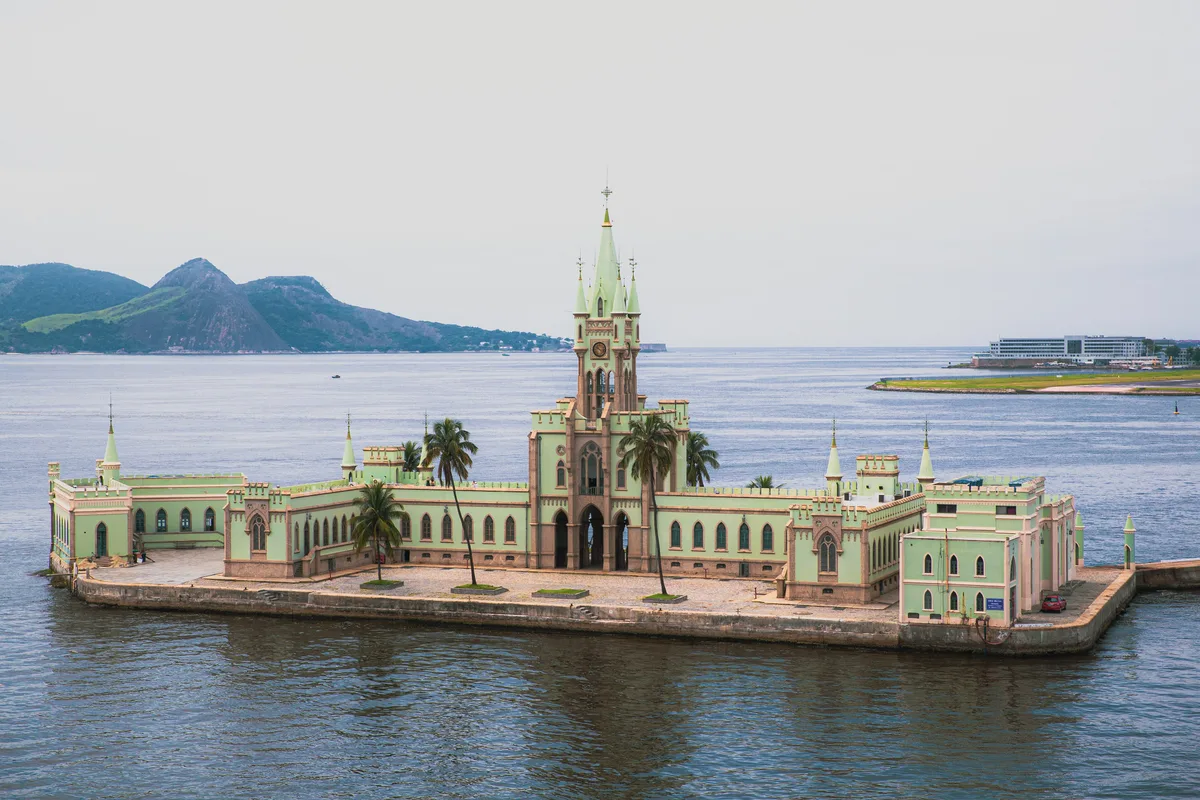 Ilha Fiscal in Rio de Janeiro - A pale green neo-Gothic palace on a small island in Guanabara Bay, looking like a...