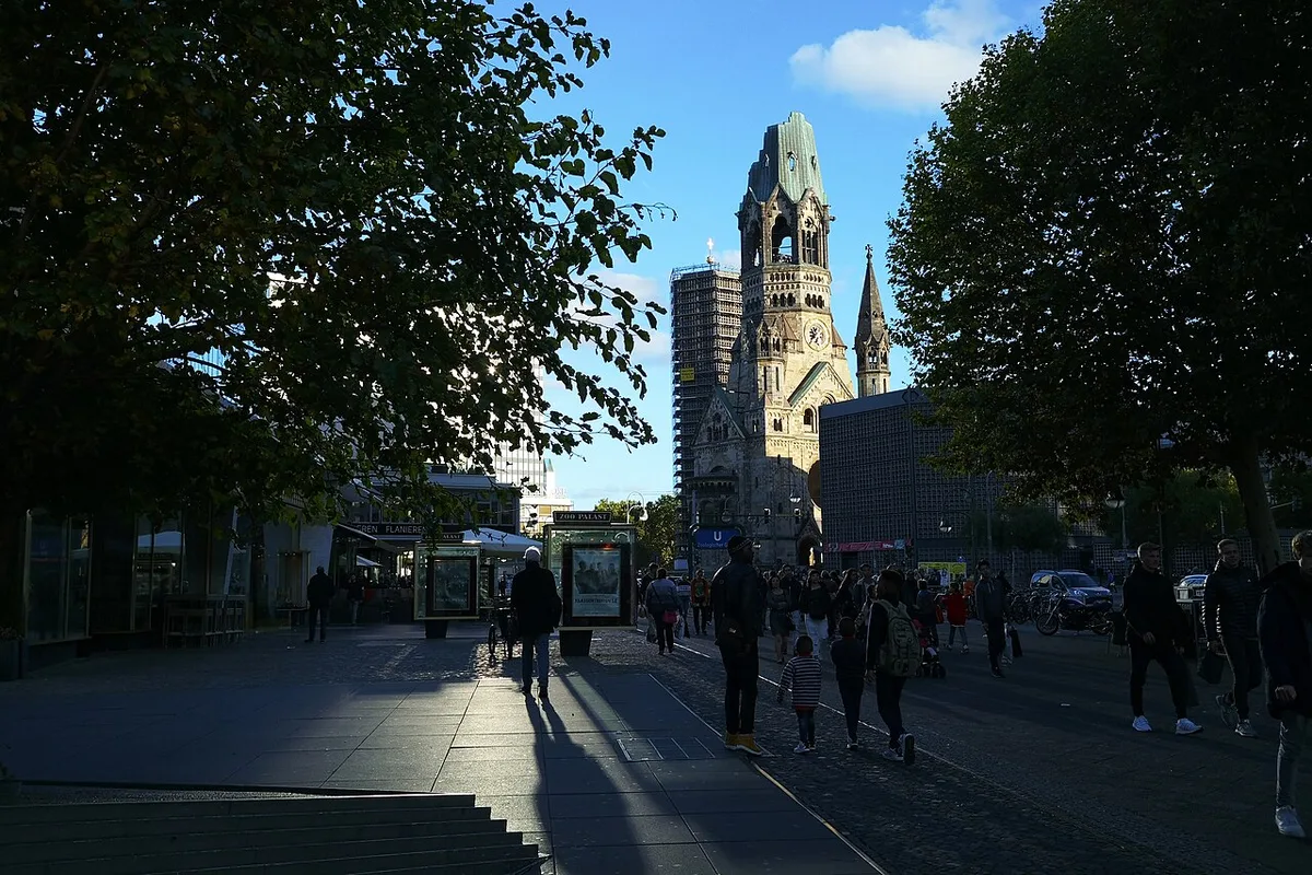 Kaiser Wilhelm Memorial Church in Berlin - A ruined Neo-Romanesque spire, Berlin's 'hollow tooth', standing beside a...