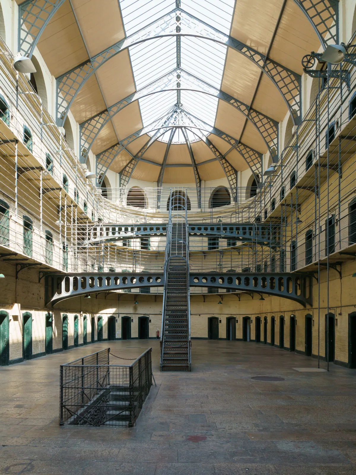Kilmainham Gaol in Dublin - A heavy Georgian stone block with a rusticated arched gateway and a carved chained hydra...