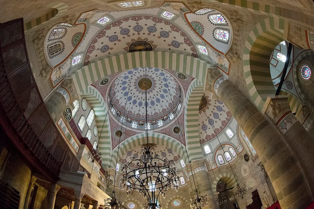 Mihrimah Sultan Mosque at the Üsküdar waterfront, a single great dome flanked by three half-domes, lit by rows of windows.