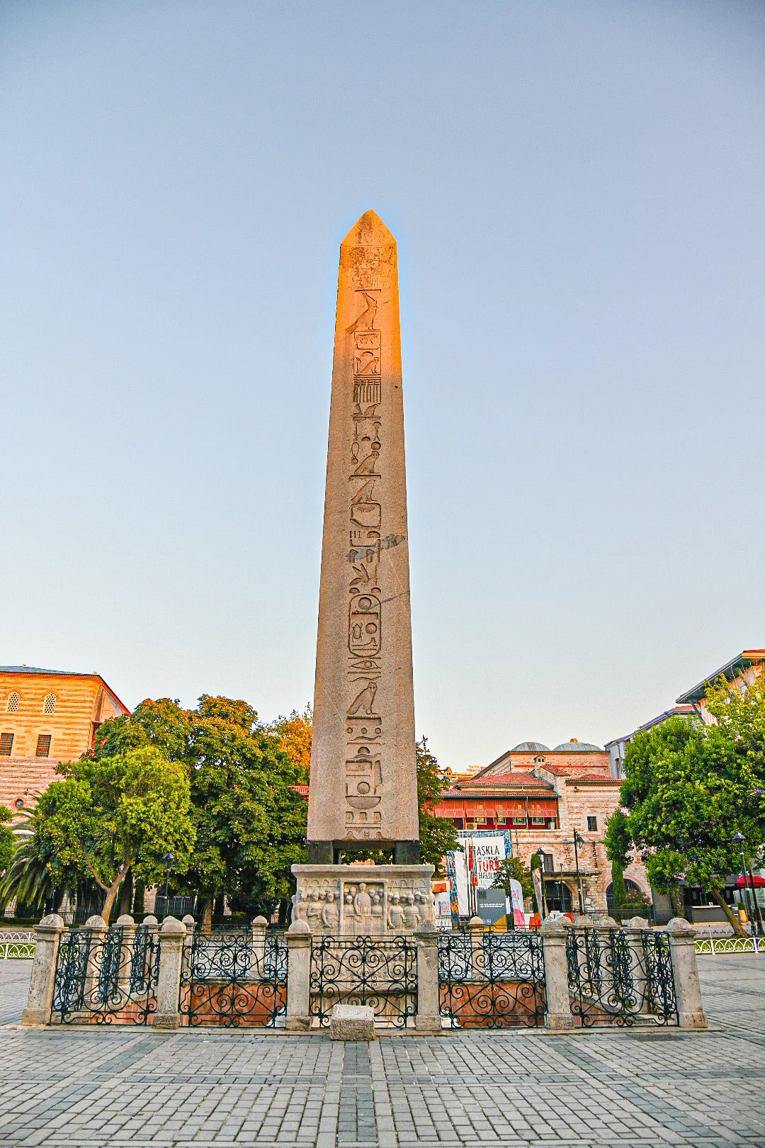 Obelisk of Theodosius (Dikilitaş) in Istanbul - A tall rose-granite obelisk carved with hieroglyphs, standing on a carved marble base in the open ground of the old Hippodrome.