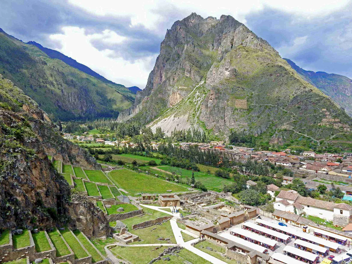 Ollantaytambo in Cusco - A steep terraced hillside topped with the Wall of the Six Monoliths, six immense pink...