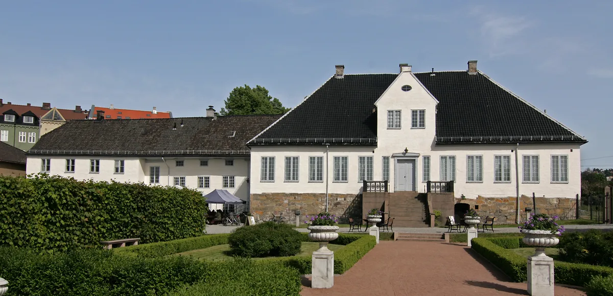 Oslo Ladegård in Oslo - A formal Baroque manor house of brick with symmetrical wings and tall windows, set in the old...
