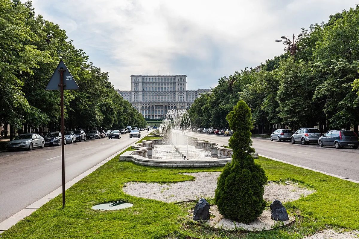 Palace of Parliament in Bucharest - An enormous white marble-and-stone monolith on a hilltop, visible from across the...