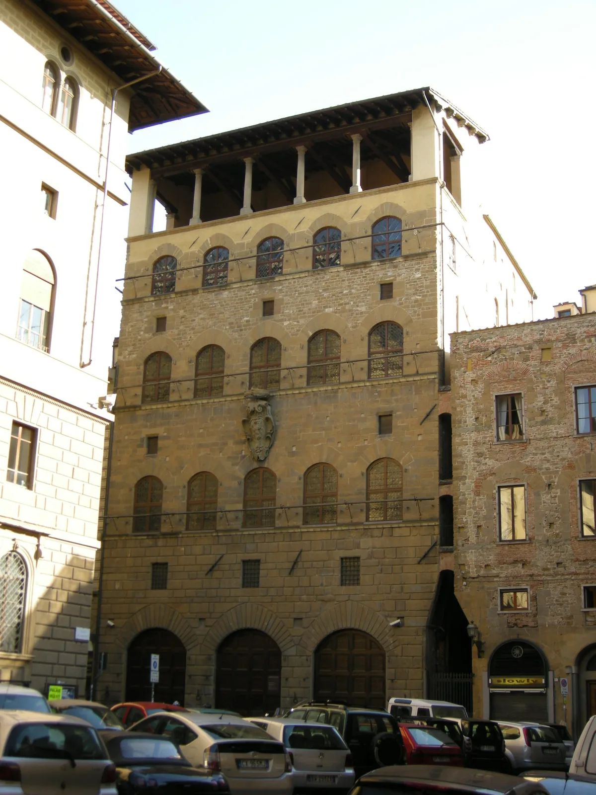 Palazzo Davanzati in Florence - A four-storey medieval tower-house of dark stone, its facade pierced by rows of pointed...
