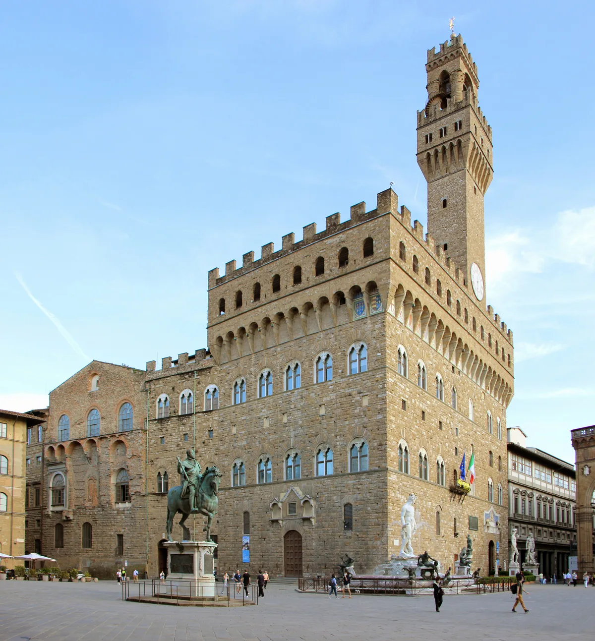 Palazzo Vecchio in Florence - A fortress-like palace with a projecting clock tower and crenellated roofline, its...