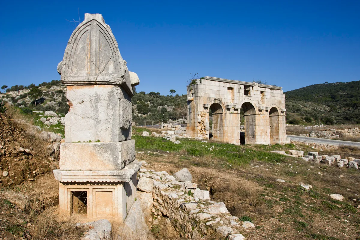 The ruins of Patara, a Lycian harbour city on a sandy coastal plain, with a Roman granary and the base of an ancient lighthouse