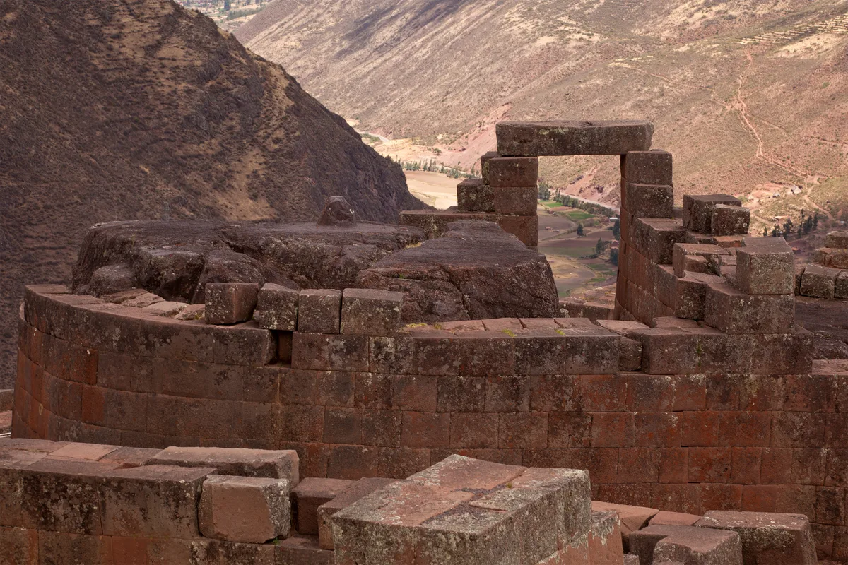Pisac's Temple of the Sun in Cusco - A polished pink-granite temple perched on a mountain spur high above the Sacred...
