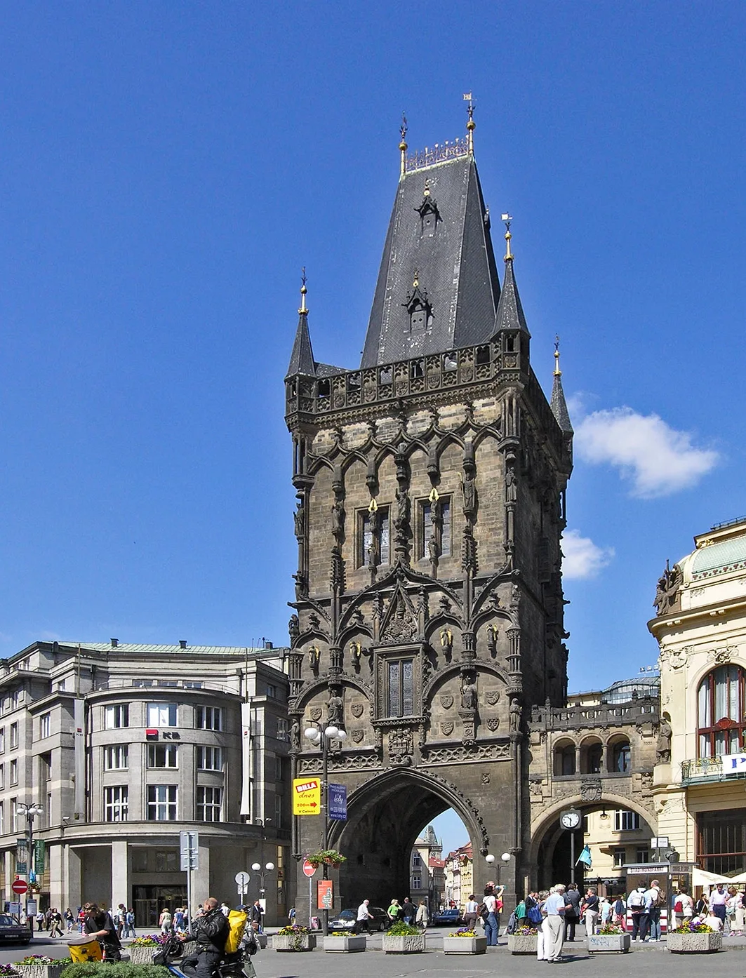 Powder Tower in Prague - A 65-metre Gothic tower with a richly decorated stone facade, standing at the entrance to the...