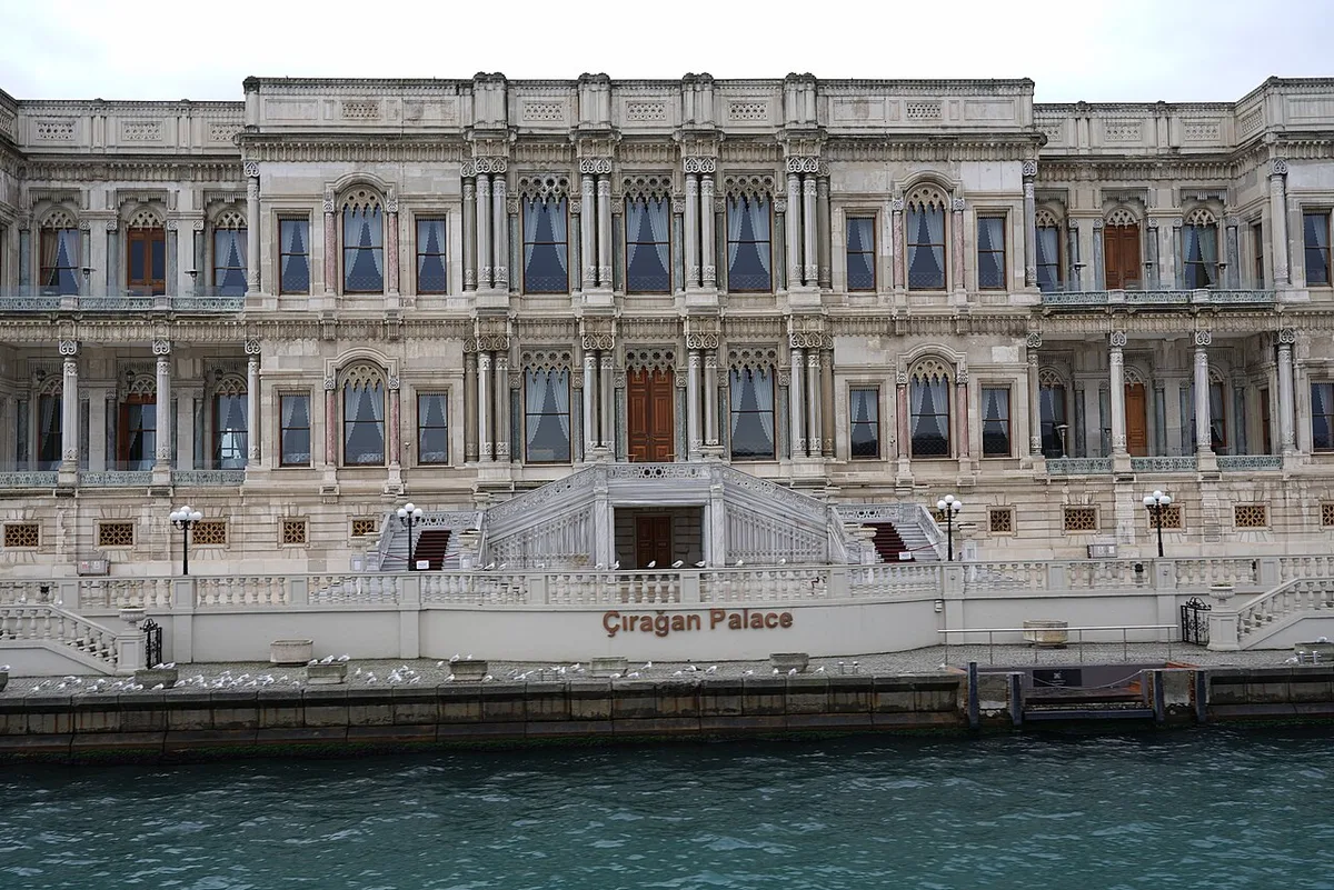 Çırağan Palace in Istanbul - An ornate white marble palace with a distinctive arched colonnade running along the...