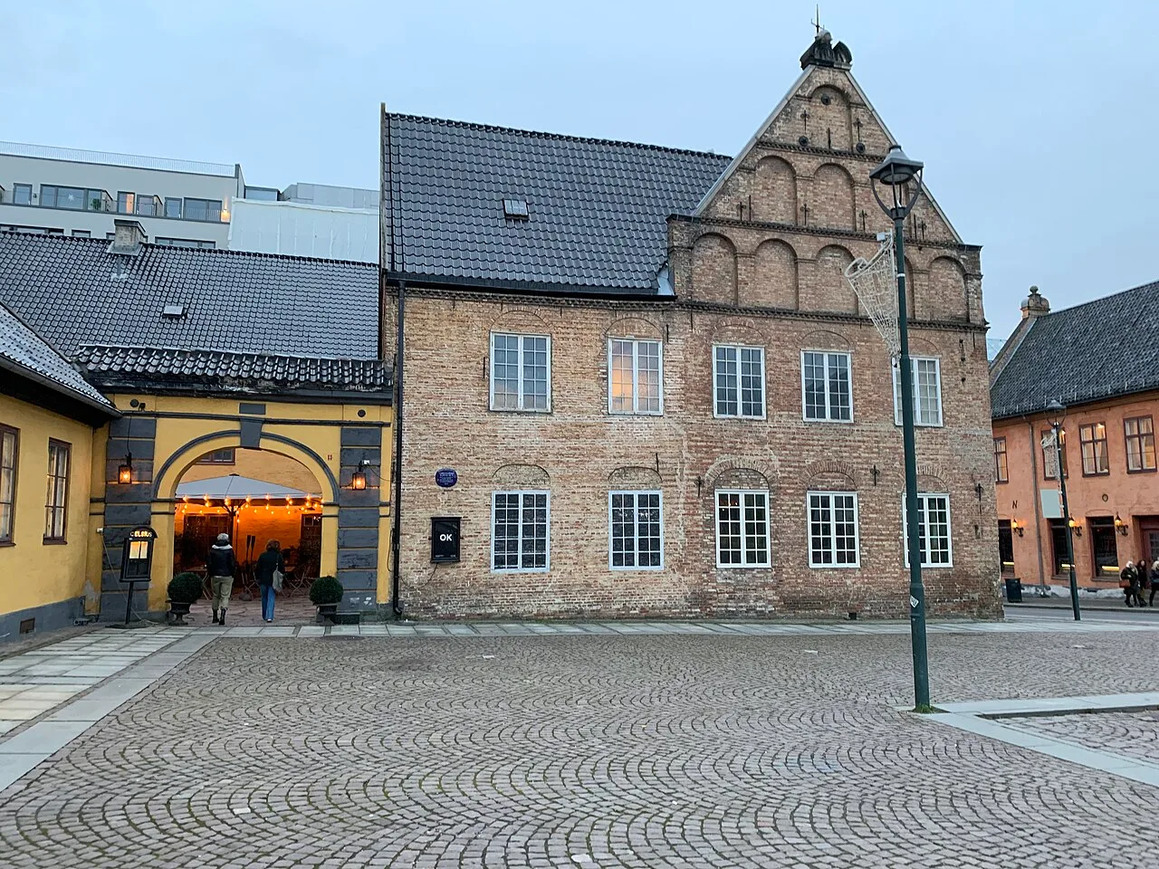 Rådmannsgården in Oslo - A two-storey brick house of imported Dutch tiles laid in red and yellow stripes, with a steep...