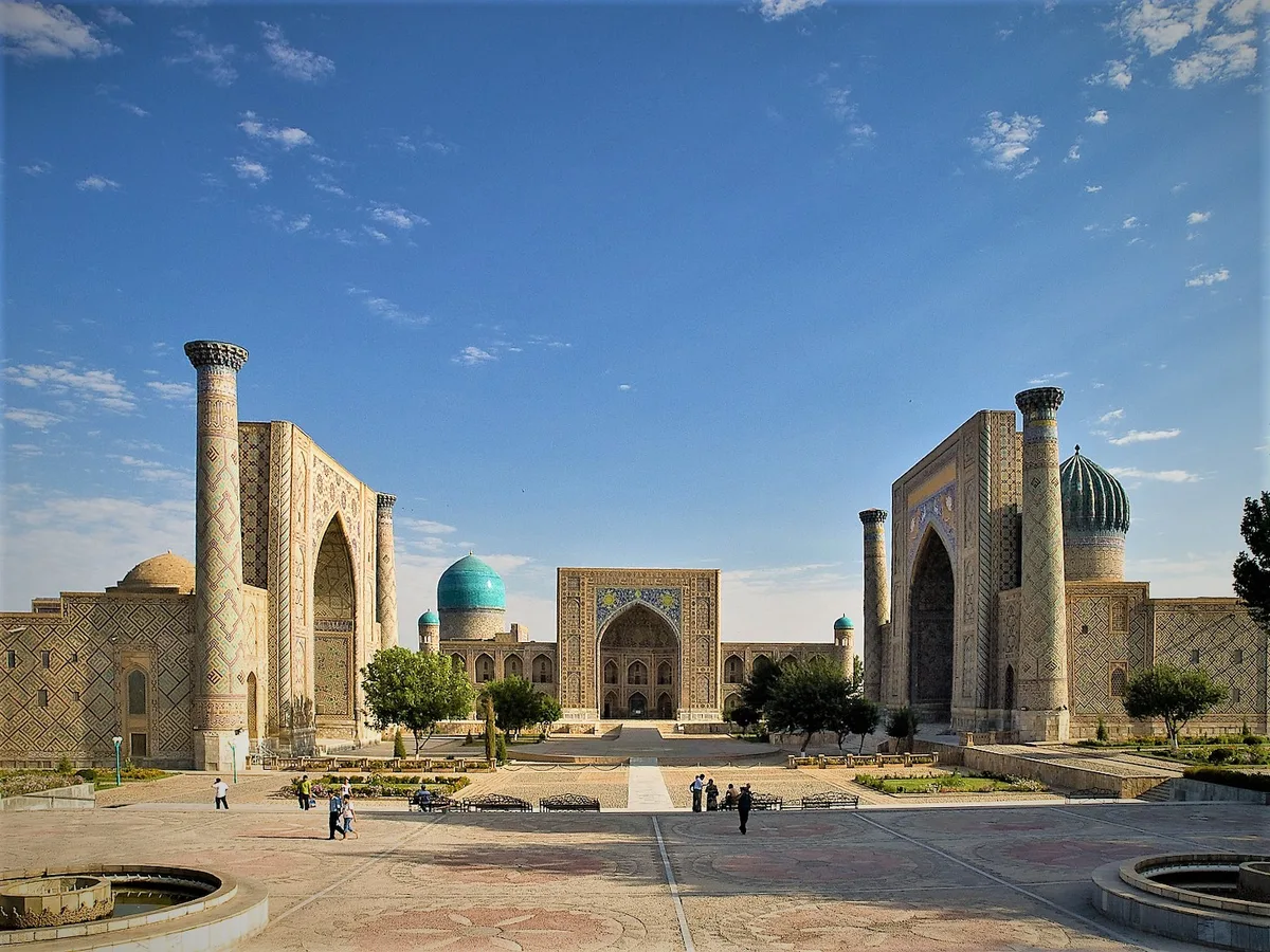 Registan Square in Samarkand - Three monumental madrasas face one another across a vast plaza of cream paving: the...