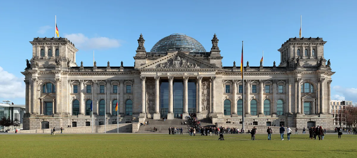 Reichstag Building in Berlin - A sandstone neo-Renaissance edifice with a modern glass dome rising from its centre, ...