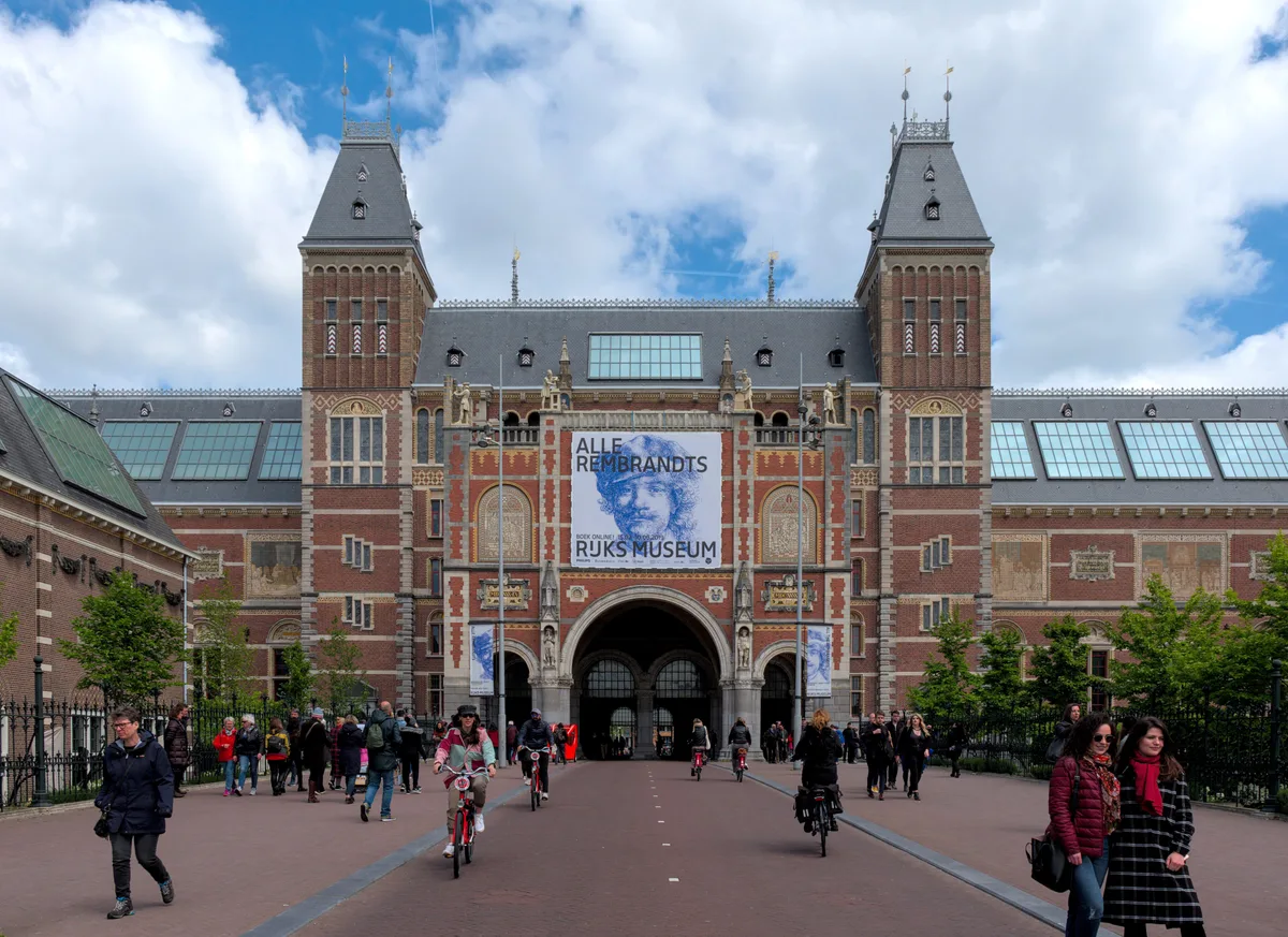 Rijksmuseum in Amsterdam - A monumental neo-Gothic palace of red brick and stone, with ornate towers, religious...