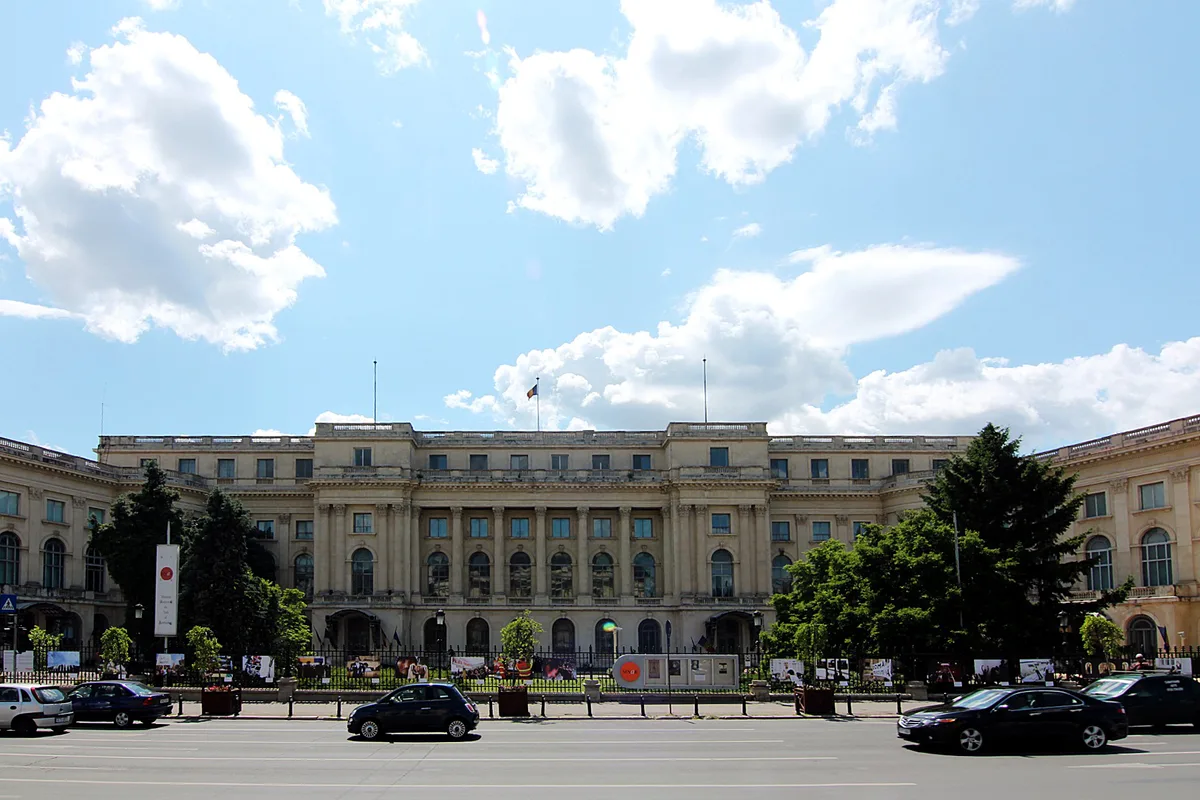Royal Palace in Bucharest - A long, sober neoclassical palace facing a broad square, its many-windowed facade broken by...