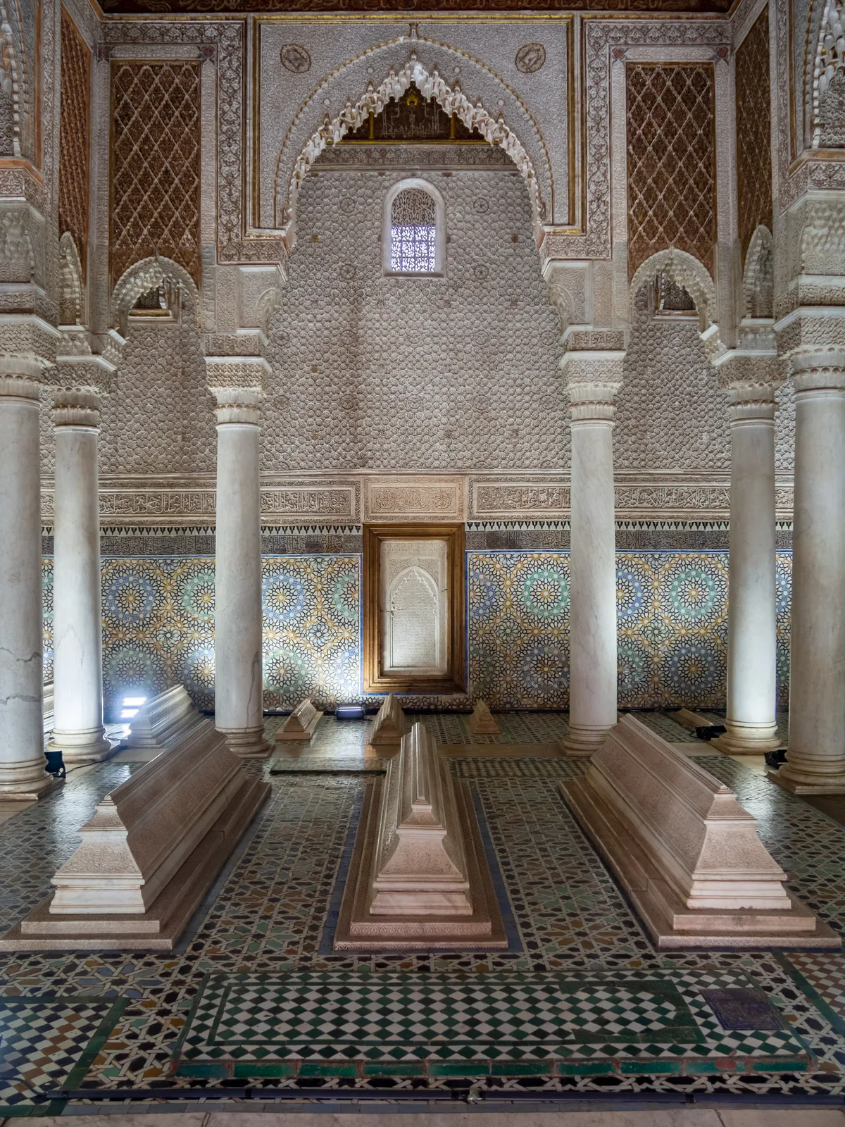 Saadian Tombs in Marrakech - A mausoleum complex of ornate marble chambers with honeycomb muqarnas ceilings, set within...