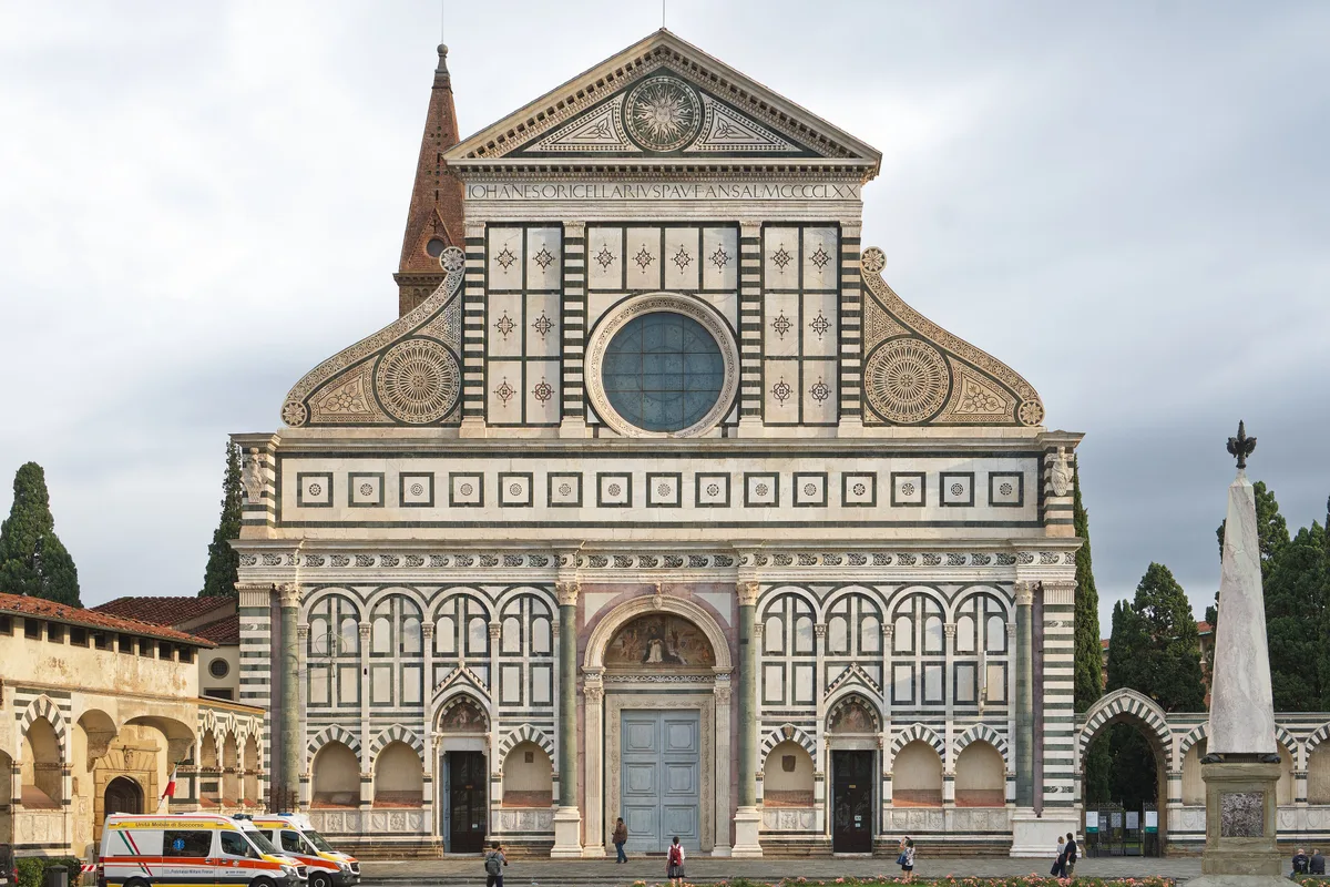 Basilica of Santa Maria Novella in Florence - A vast basilica whose white-and-green marble facade is crowned by curling...