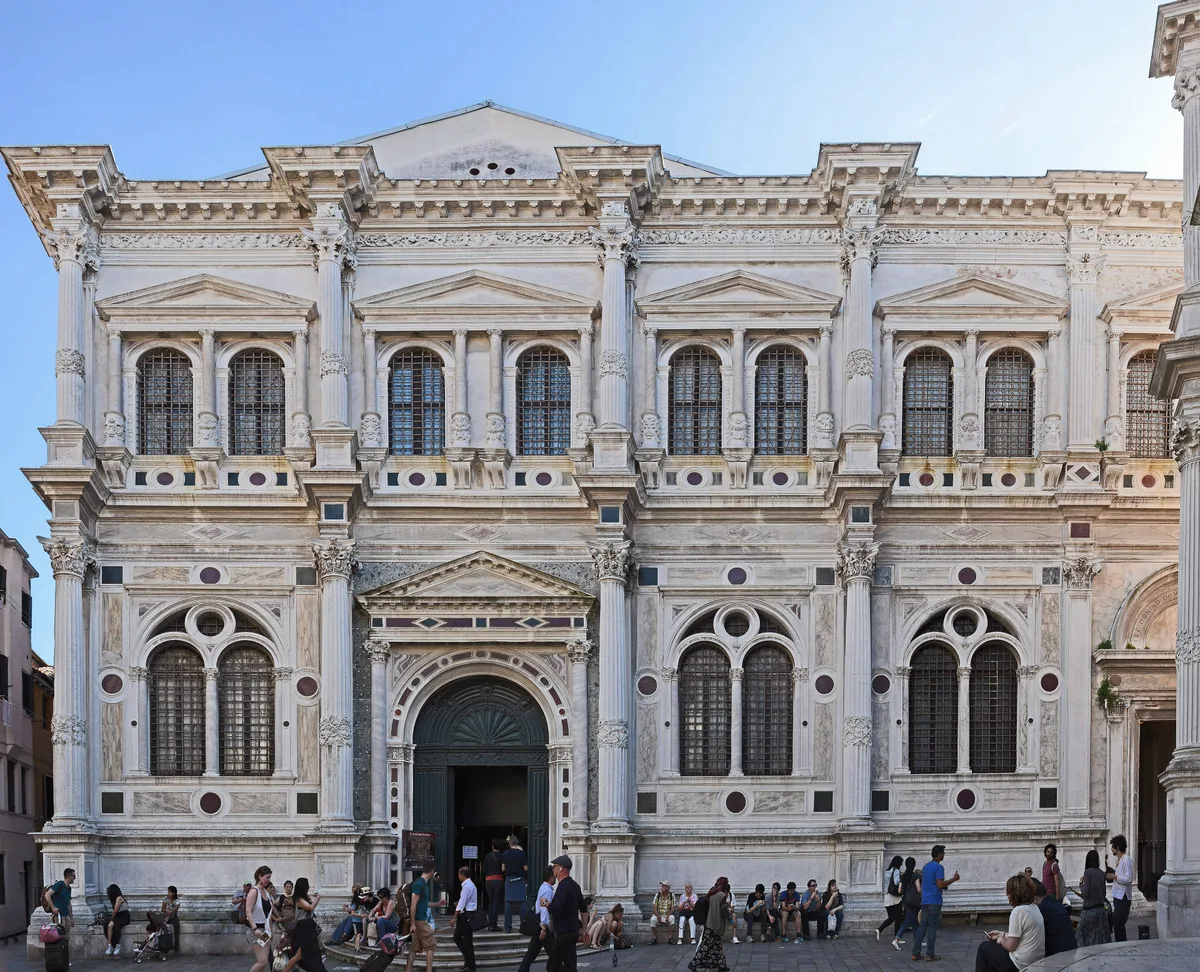 Scuola Grande di San Rocco in Venice - A severe white Istrian stone facade with paired Corinthian columns below and...