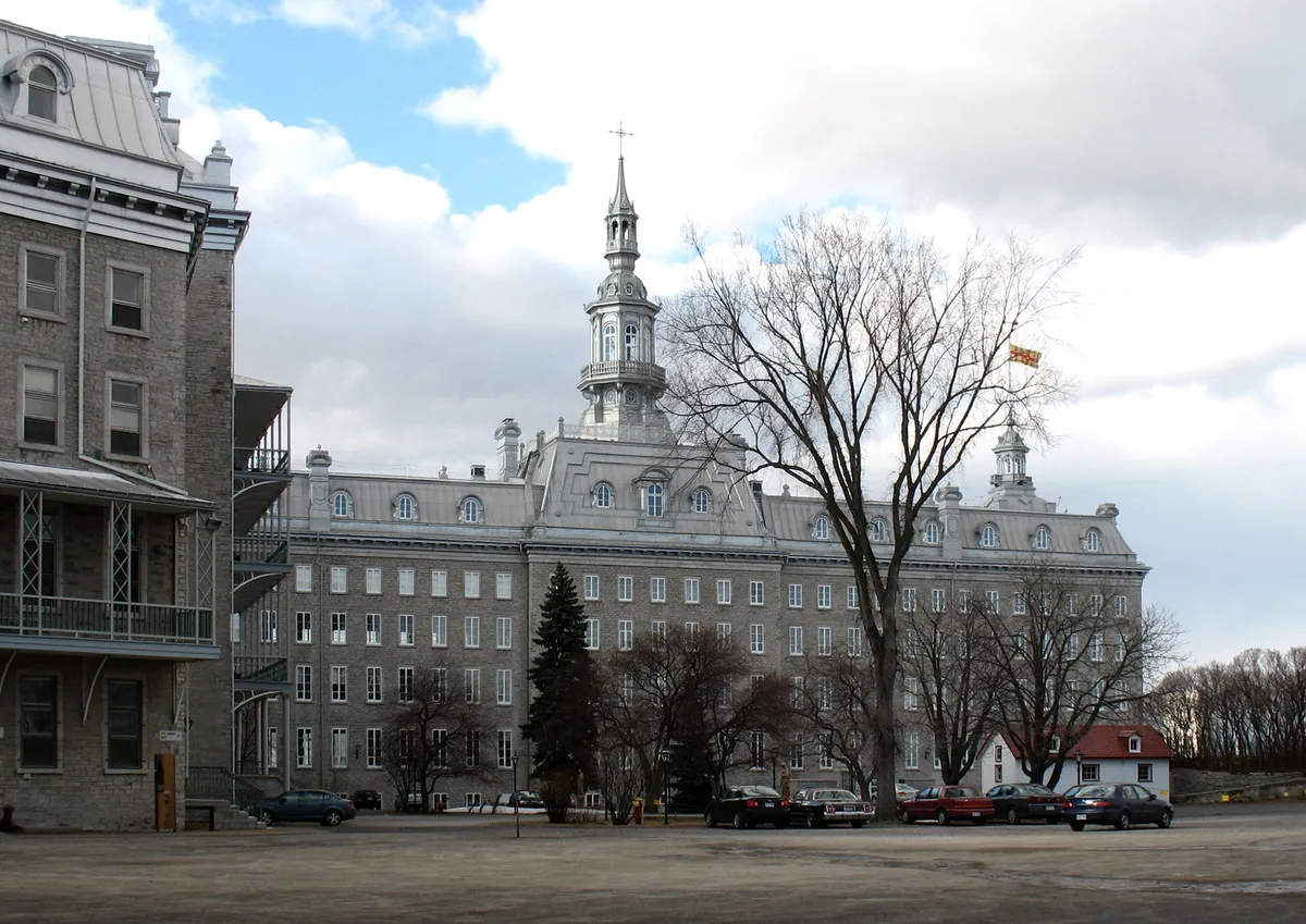 Séminaire de Québec in Québec City - A long range of stone buildings and courtyards opposite the cathedral, with a pedimented carriage gate