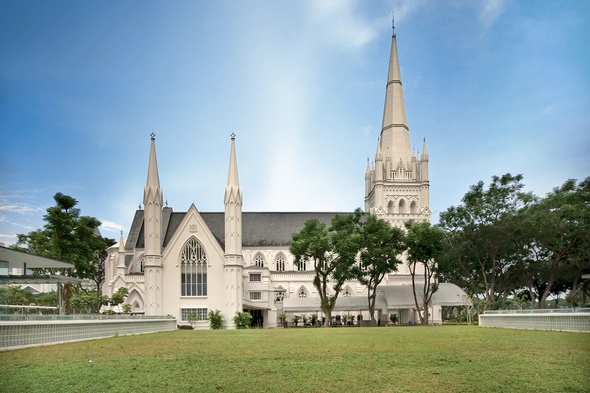 St. Andrew's Cathedral in Singapore - A pale Gothic cathedral with twin spires and pointed arched windows rising beside...