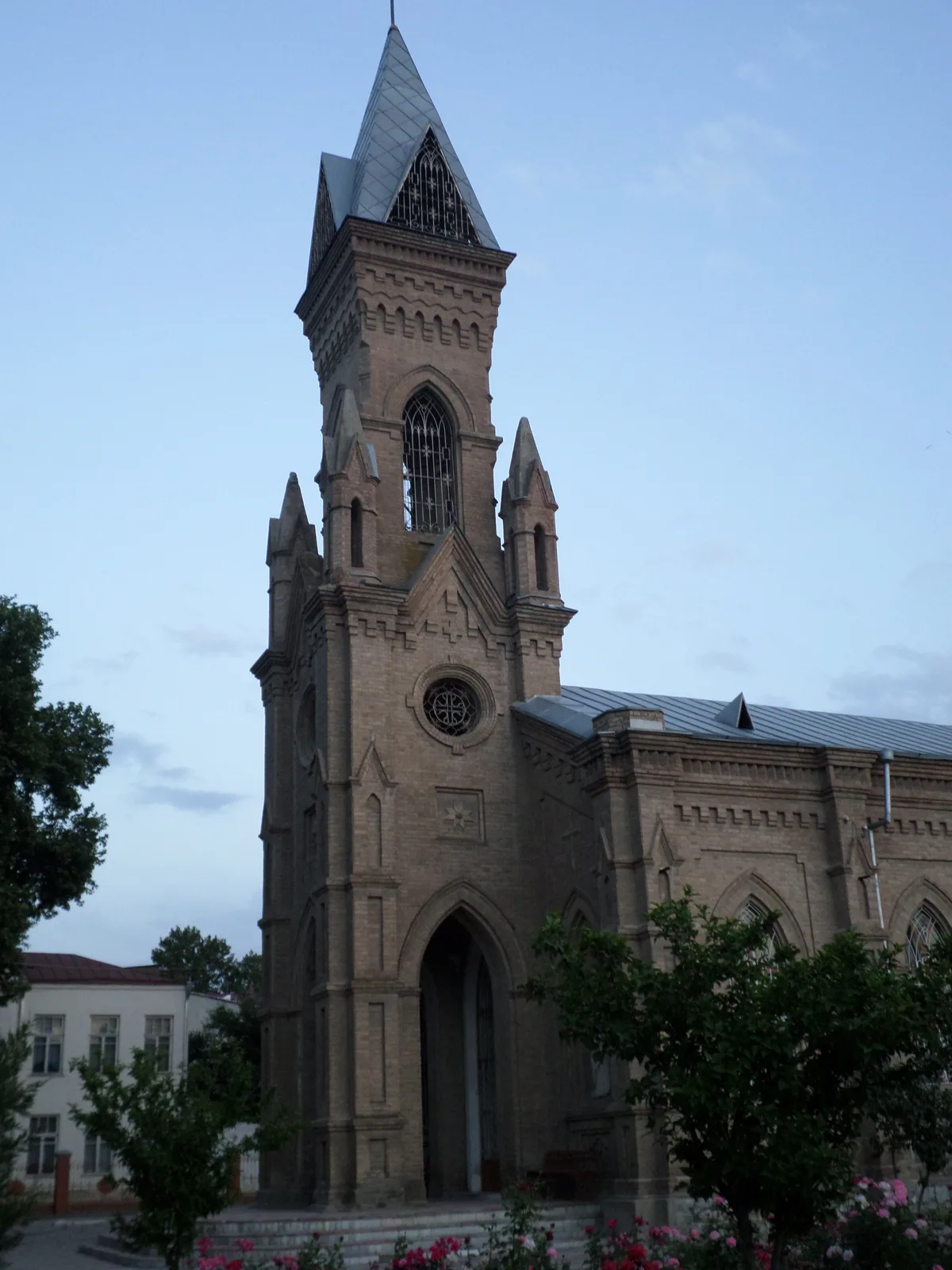 St. John the Baptist Church in Samarkand - A modest brick church with pointed neo-Gothic arches and a small bell tower...