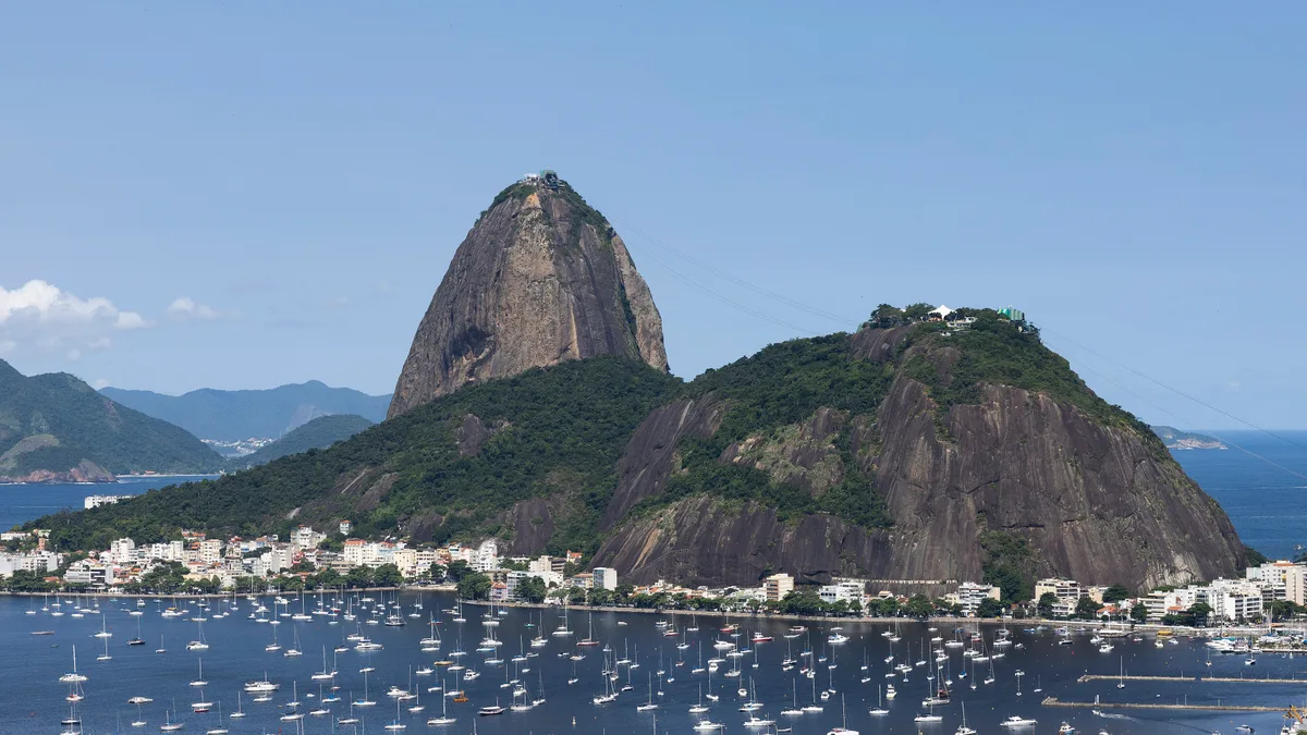 Sugarloaf Mountain in Rio de Janeiro - A 396-metre granite and quartz peak rising straight from the water at the mouth...