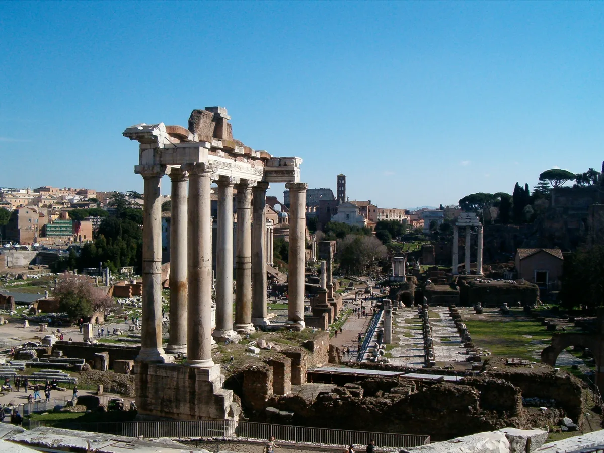 Temple of Saturn in Rome - Eight weathered granite columns crowned by Ionic capitals, supporting the remnant of a...